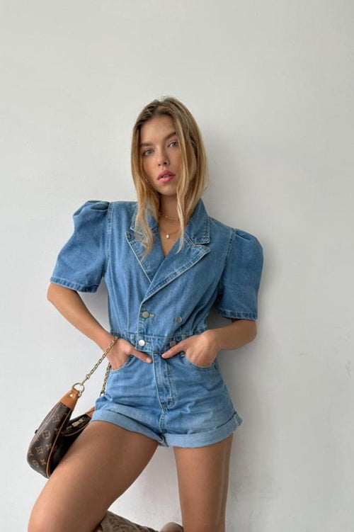 Woman wearing a denim outfit against a plain background
