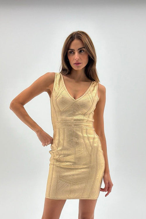 Woman wearing a gold dress on a white background