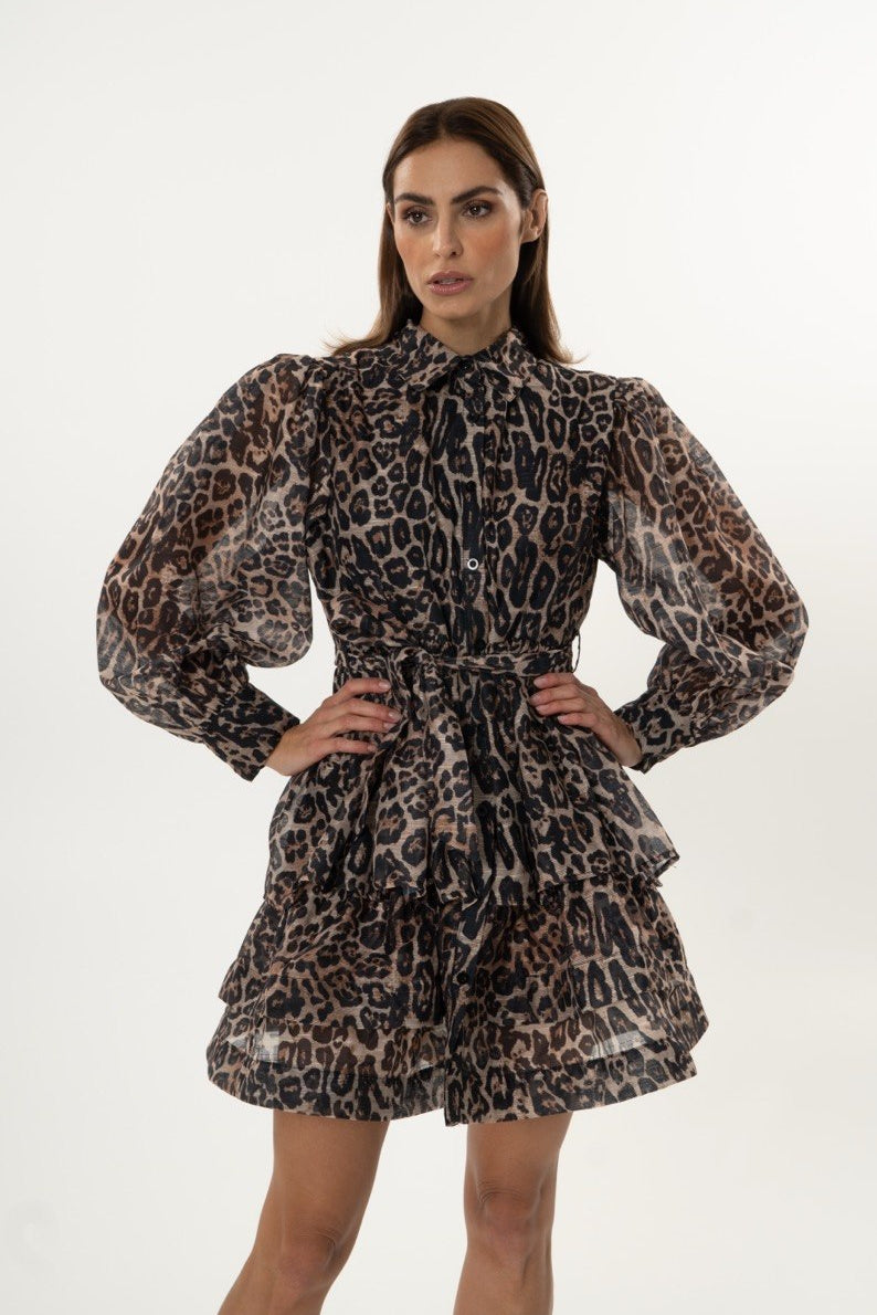 Woman wearing a leopard print dress on a white background